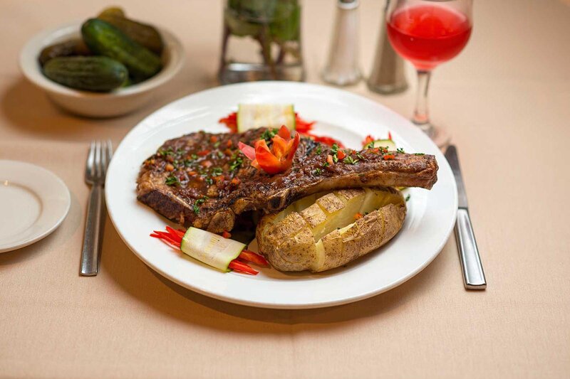 Ribeye steak with baked potato and vegetables