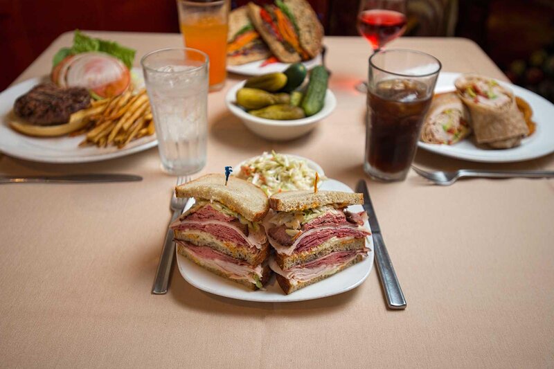 Multiple sandwiches with focus on corned beef sandwich